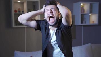 A mentally ill man with psychological disorders is going crazy at home. The crazy man who is alone in the house is screaming, having a nervous breakdown and is mentally unstable. video