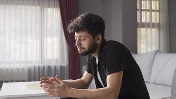 Crazy man with mental illness talking to himself at home alone. The man with schizophrenia goes crazy at home alone and does strange things. Concept of paranoia or schizophrenia and insanity. video