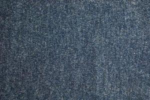 Texture of blue knitted fabric. Abstract modern knitted texture in blue color. Dark knitted background photo