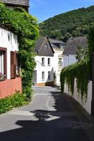 Winningen, Germany, 2022 - narrow village street with vine on the walls and houses photo