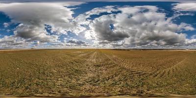 spherical 360 hdri panorama among farming field with clouds on blue sky in equirectangular seamless projection, use as sky replacement in drone panoramas, game development as sky dome or VR content photo