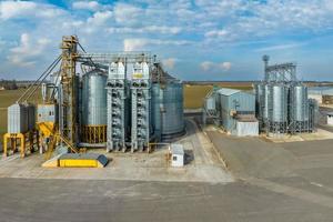 aerial view of agro-industrial complex with silos and grain drying line photo