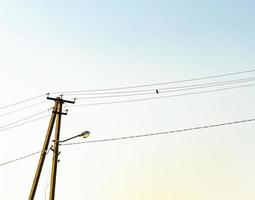 Power electric pole with line wire on colored background close up photo