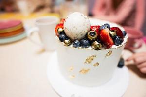 Happy birthday to you. Cake with fruits, blueberries and strawberries. photo