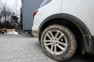 Close up mud dirty wheel of off road SUV car. Adventure in mountains. photo