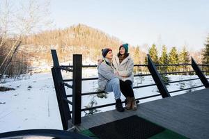 Couple in love on terrace off grid tiny house in the mountains. photo