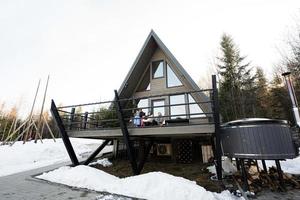 Mother with four children sit on terrace off grid tiny house in the mountains. photo