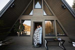 Couple in love on terrace off grid tiny house in the mountains. photo