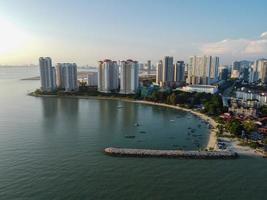 Aerial view traditional fisherman jetty and condominium building photo