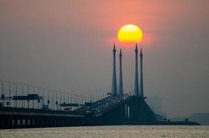 Egg yolk sunrise at Penang Bridge photo