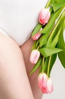 Woman's bikini area with tulips photo