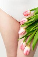 Woman's bikini area with tulips photo