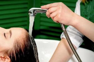 Woman washing hair in salon photo