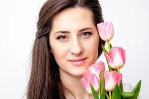 Portrait of woman with pink tulips photo