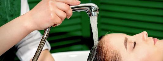 Woman washing hair in salon photo