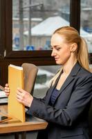 Businesswoman with folder with documents photo