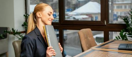 Businesswoman with folder with documents photo