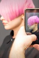 Hairdresser takes pictures of hairstyle photo