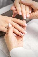 Manicurist showing manicure on fingers photo