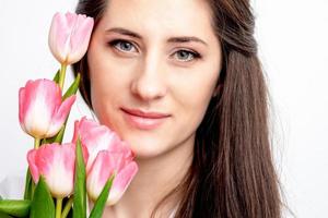 Portrait of woman with pink tulips photo