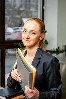 Businesswoman with folder with documents photo