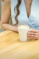 Female hands with cup of coffee photo