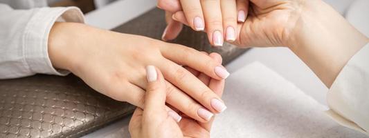 Manicurist showing manicure on fingers photo