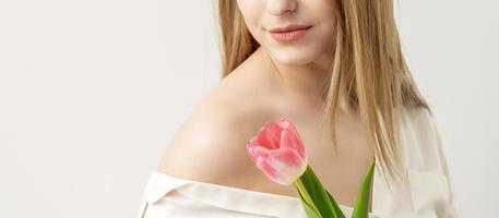 Young woman with one tulip photo