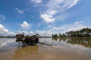 Rice paddy tractor in the flood field photo