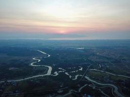 River flow towards sea cross plantation photo