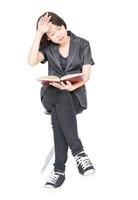 Woman reading a book sitting on chair photo