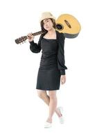 Woman carrying acoustic guitar on shoulder photo