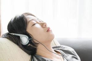 Young asian woman short hair listening music photo