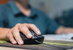 Close-up image Hand Human using computer mouse coding or data analysis Programmer, developer or employee on tech for software code, programming photo