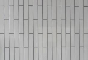 Small white tiled wall with vertical pattern used for background or texture in decorative art work or template photo