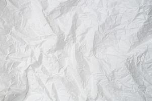 Wrinkled or crumpled white stencil paper or tissue after use in toilet or restroom with large copy space used for background texture in decorative art work photo