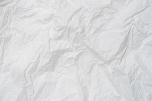 Wrinkled or crumpled white stencil paper or tissue after use in toilet or restroom with large copy space used for background texture in decorative art work photo