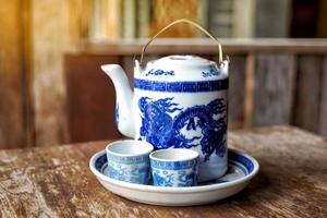Set of bowls and teacups chinese art blue dragon painting pattern. Soft and selective focus. photo