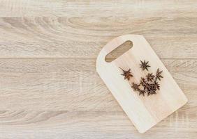 Top view Star anise seed on wood chopping board photo