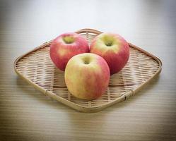 Red apple in basket photo