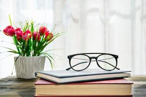 Eye glasses are placed on books photo