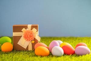 Easter eggs on grass and gift box photo