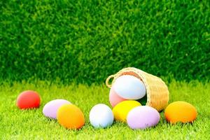 Easter eggs in the basket on green grass photo