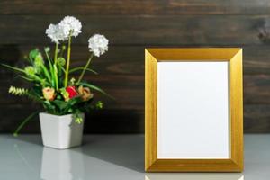 Picture mock up with golden frame and flower vase bouquet photo