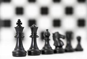 Set of Black chess pieces on white background photo