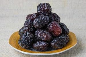 Delicious ajwa dates kurma nabi, Much sought after during the month of Ramadan as a dish for breaking the fast, ramadhan kareem, empty space, copy space. photo