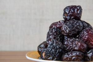 Delicious ajwa dates kurma nabi, Much sought after during the month of Ramadan as a dish for breaking the fast, ramadhan kareem, empty space, copy space. photo