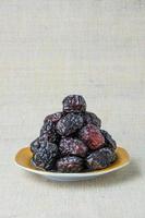 Delicious ajwa dates kurma nabi, Much sought after during the month of Ramadan as a dish for breaking the fast, ramadhan kareem, empty space, copy space. photo