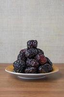 Delicious ajwa dates kurma nabi , Much sought after during the month of Ramadan as a dish for breaking the fast, ramadhan kareem, empty space, copy space. photo