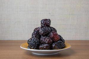 Delicious ajwa dates kurma nabi, Much sought after during the month of Ramadan as a dish for breaking the fast, ramadhan kareem, empty space, copy space. photo